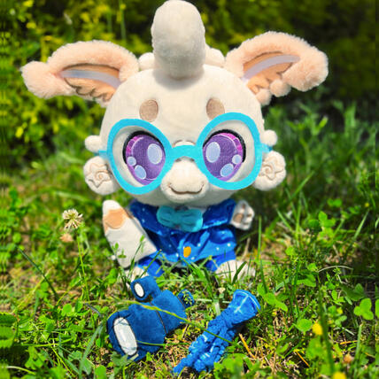 Laisy Luna Moth Plushpanion Laisy Luna Moth Plushpanion: A white mothy plush sits on a black mat. The white fluffy moth is wearing light blue glasses, a star (white dot) cobalt blue blazer, with matching navy blue trousers. They're holding a white pencil and dark blue telescope prop.