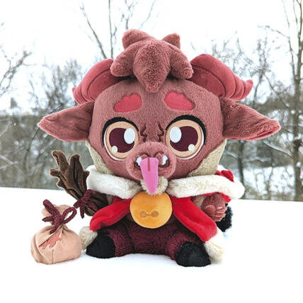 Kidd Krampus Plushpanion Kidd Krampus Plushpanion: A brown goat-like plush sits in the snow. Wearing his lush red winter cloak (hood down) and yellow jingle bell necklace. He hold his magnet twig prop in his hand and his magnetic tongue at his mouth. Kidd has yellow eyes, dark red